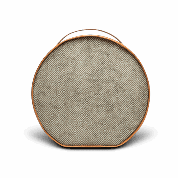 Round portable speaker with herringbone fabric