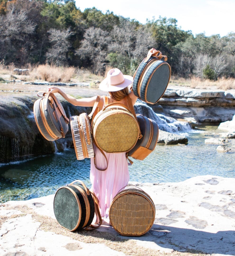 Woman in pink dress with vintage suitcases.